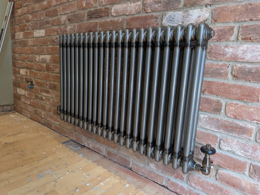 Designer radiator fitted with matching corner valves.